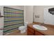 Bathroom featuring a single sink, tile flooring, and a shower with a striped shower curtain at 5714 Kingletsound Pl, Lithia, FL 33547