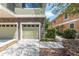 Attached garage with stone facade and neutral-toned door provides convenient parking and complements the home's exterior at 5714 Kingletsound Pl, Lithia, FL 33547