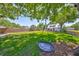 Serene backyard featuring lush greenery, a swing, and mature trees, creating a tranquil outdoor oasis at 609 4Th Sw Ave, Ruskin, FL 33570