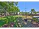 Spacious backyard featuring a tree swing and lush green grass, creating a serene outdoor space at 609 4Th Sw Ave, Ruskin, FL 33570