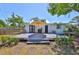 Charming backyard featuring a large deck with umbrella, a fenced yard, and lush landscaping at 609 4Th Sw Ave, Ruskin, FL 33570