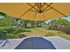 Lush backyard featuring a large deck with umbrella, a fenced yard, and mature trees at 609 4Th Sw Ave, Ruskin, FL 33570