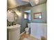 Stylish bathroom with a classic sink, decorative mirror, and neutral color palette at 609 4Th Sw Ave, Ruskin, FL 33570