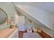Bedroom room featuring wooden floors, a sloped ceiling, and light green wooden plank walls at 609 4Th Sw Ave, Ruskin, FL 33570