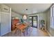 Dining room features wood table, chairs, an elegant light fixture, and double doors to the backyard at 609 4Th Sw Ave, Ruskin, FL 33570