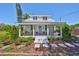 Charming home with a welcoming front porch, swing, and beautiful landscaping at 609 4Th Sw Ave, Ruskin, FL 33570