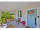 Charming front porch with swing, stylish décor, and view of the front yard at 609 4Th Sw Ave, Ruskin, FL 33570
