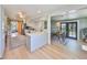 Bright kitchen with white cabinets, an island, stainless steel appliances, and a view into the dining area at 609 4Th Sw Ave, Ruskin, FL 33570