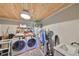 Convenient laundry room with washer, dryer, sink, wood ceiling, and storage at 609 4Th Sw Ave, Ruskin, FL 33570