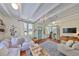 Bright living room featuring a cozy seating area, wood floors, and a charming front door at 609 4Th Sw Ave, Ruskin, FL 33570