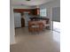 Bright kitchen featuring an island with seating, tiled flooring, and ample cabinet space at 7112 Eldorado Dr, Tampa, FL 33615