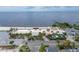 Aerial view of beach front restaurant, surrounded by palm trees and overlooking the bay under a partly cloudy sky at 803 Bahia Del Sol Dr # 66, Ruskin, FL 33570