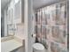 Cozy bathroom featuring a decorative curtain in a shower-tub combination and a vanity with storage at 803 Bahia Del Sol Dr # 66, Ruskin, FL 33570