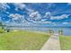 A beach access on a sunny day, perfect for enjoying the ocean view under a partly cloudy sky at 803 Bahia Del Sol Dr # 66, Ruskin, FL 33570