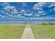 A sunny and clear beach access for enjoying the beautiful ocean view under a partly cloudy sky at 803 Bahia Del Sol Dr # 66, Ruskin, FL 33570