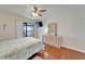 Bedroom with wood floors, balcony access offering a view, ceiling fan, and dresser with decor at 803 Bahia Del Sol Dr # 66, Ruskin, FL 33570