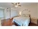 Bedroom with wood floors, white closet, ceiling fan and decorated wall and night stand at 803 Bahia Del Sol Dr # 66, Ruskin, FL 33570