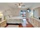 Bedroom with wood floors, balcony access offering a view, ceiling fan, and dresser with decor at 803 Bahia Del Sol Dr # 66, Ruskin, FL 33570