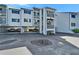 View of the condo building featuring covered parking and staircase access to the upper levels at 803 Bahia Del Sol Dr # 66, Ruskin, FL 33570