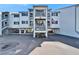 Exterior angle of condo building featuring parking and staircase access to the upper levels at 803 Bahia Del Sol Dr # 66, Ruskin, FL 33570