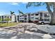 Exterior facade of condo buildings, with tropical landscaping and shaded parking at 803 Bahia Del Sol Dr # 66, Ruskin, FL 33570