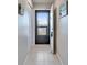 Hallway with tiled floors and louvered door on the left at 803 Bahia Del Sol Dr # 66, Ruskin, FL 33570