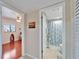 Hallway view to a bedroom with wood floors and fan, and a bathroom with shower at 803 Bahia Del Sol Dr # 66, Ruskin, FL 33570