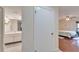 Hallway view showcasing the bathroom, a bedroom with wood floors, and a door in between at 803 Bahia Del Sol Dr # 66, Ruskin, FL 33570