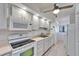 Bright kitchen featuring white appliances and tile flooring at 803 Bahia Del Sol Dr # 66, Ruskin, FL 33570