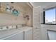Bright laundry room features a white washer and dryer set, shelving and natural light at 803 Bahia Del Sol Dr # 66, Ruskin, FL 33570
