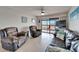 Cozy living room featuring tile flooring, a leather couch, and glass sliding doors to an outdoor patio at 803 Bahia Del Sol Dr # 66, Ruskin, FL 33570