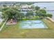 Aerial view of a park with playground, basketball court, and green space, near a waterfront area at 803 Bahia Del Sol Dr # 66, Ruskin, FL 33570