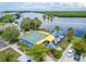 Aerial view of a waterfront restaurant with outdoor seating and vibrant yellow and green accents at 803 Bahia Del Sol Dr # 66, Ruskin, FL 33570