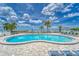 Community swimming pool with beach views and lounge chairs available for relaxing under a partly cloudy sky at 803 Bahia Del Sol Dr # 66, Ruskin, FL 33570
