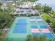 An aerial view showcasing multiple well-maintained tennis and pickleball courts surrounded by lush greenery at 803 Bahia Del Sol Dr # 66, Ruskin, FL 33570