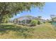 Beautiful lawn with mature landscaping, offering privacy and scenic views at 8847 Bel Meadow Way, Trinity, FL 34655