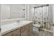 Bathroom featuring a tub with shower, framed mirror, and a dark wood vanity at 8847 Bel Meadow Way, Trinity, FL 34655