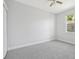 Bright carpeted bedroom with closet, a window and a ceiling fan at 8847 Bel Meadow Way, Trinity, FL 34655