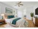 Comfortable bedroom with ensuite bathroom, ceiling fan and hardwood floors at 8847 Bel Meadow Way, Trinity, FL 34655