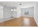 Open dining area features hardwood floors, a modern light, and an exterior view at 8847 Bel Meadow Way, Trinity, FL 34655