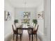 Elegant dining room with modern decor, stylish lighting, and seating for six at 8847 Bel Meadow Way, Trinity, FL 34655