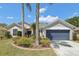 Charming single-story home featuring a well-maintained lawn and a two-car garage with a blue door at 8847 Bel Meadow Way, Trinity, FL 34655