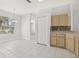 Bright eat-in kitchen area with white tile floors, a window, and partial view of cabinets at 8847 Bel Meadow Way, Trinity, FL 34655