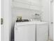 Laundry room with washer, dryer, and wire shelving for storage at 8847 Bel Meadow Way, Trinity, FL 34655