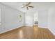 Spacious main bedroom with neutral walls, ceiling fan, and ensuite bathroom access at 8847 Bel Meadow Way, Trinity, FL 34655