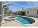 Screened-in pool with hot tub with brick paved deck and well-maintained backyard at 8847 Bel Meadow Way, Trinity, FL 34655