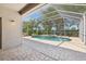 Screened-in lanai featuring a beautiful pool and hot tub, perfect for relaxation and entertainment at 8847 Bel Meadow Way, Trinity, FL 34655