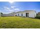 Expansive, green backyard enclosed with a white fence, offering privacy and ample space at 1506 Climbing Dayflower Dr, Ruskin, FL 33570