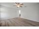 This empty bedroom is bathed in natural light and features light wood-look floors and a ceiling fan, creating a bright and airy atmosphere at 1506 Climbing Dayflower Dr, Ruskin, FL 33570