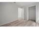 Bright bedroom with wood-look floors, a ceiling fan, and a closet with bi-fold doors at 1506 Climbing Dayflower Dr, Ruskin, FL 33570